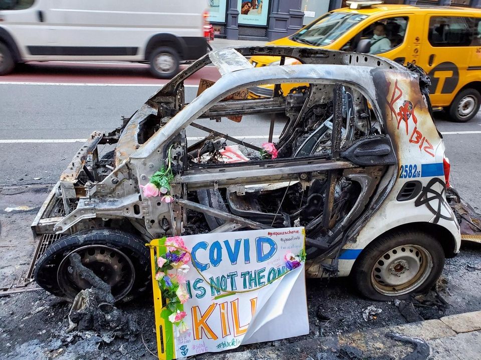 A damaged police car in front of Bloomindales