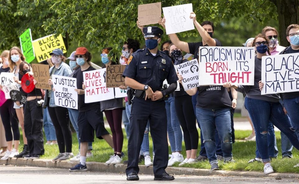 A Suffolk County police officer keeps watch over