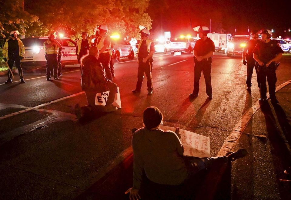 Two men sit on the William Floyd Parkway