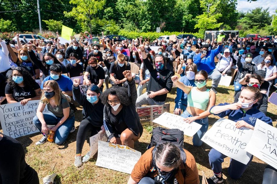 Hundreds of demonstrators take a knee demanding justice