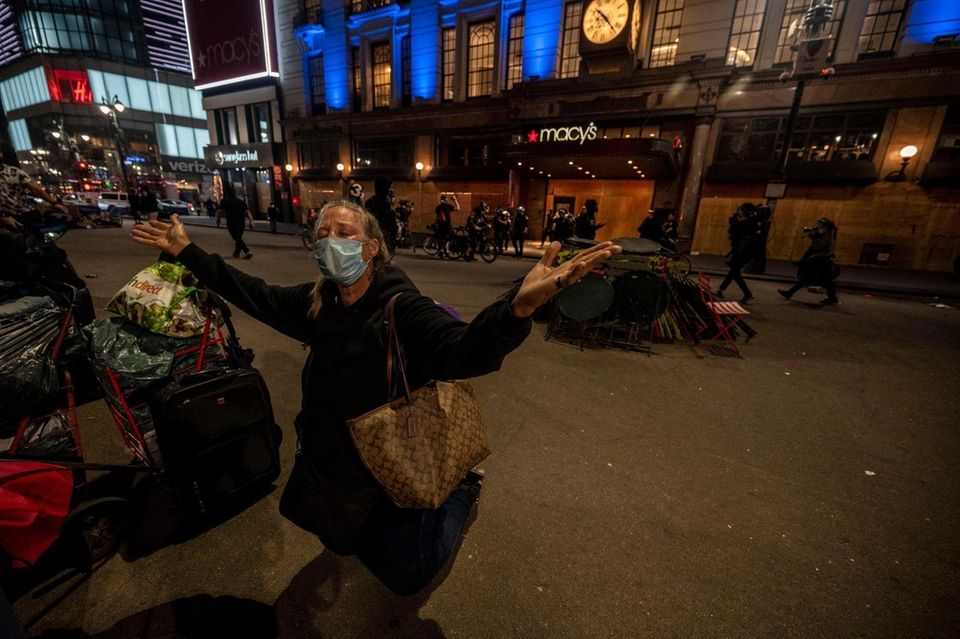 A woman prays as police secure the iconic