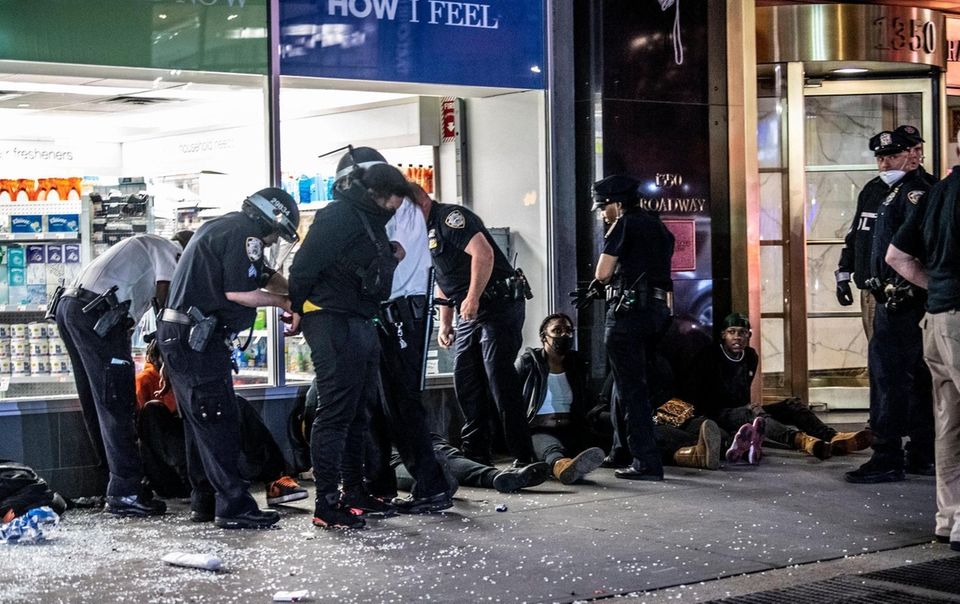 Police officers surround a group of people suspected