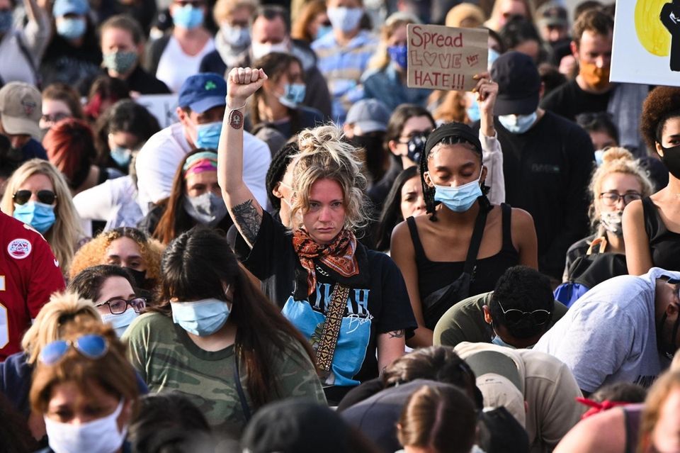 Alex Spergel, of Long Beach, raises her fist