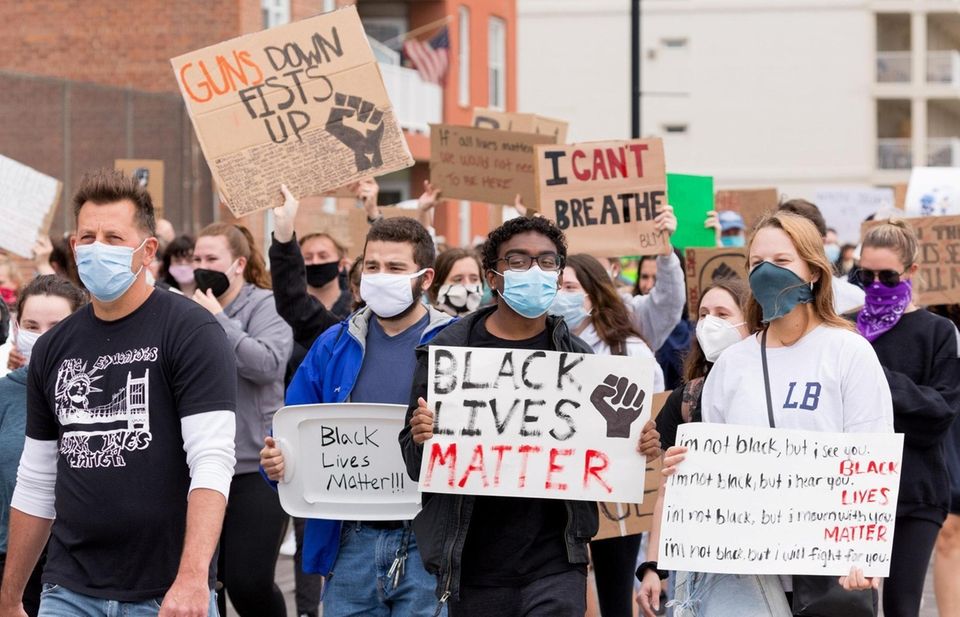 Protestors demonstrate on the Long Beach Boardwalk Tuesday,