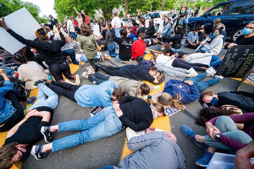 Protestors in Bridgehampton lie in the road, with
