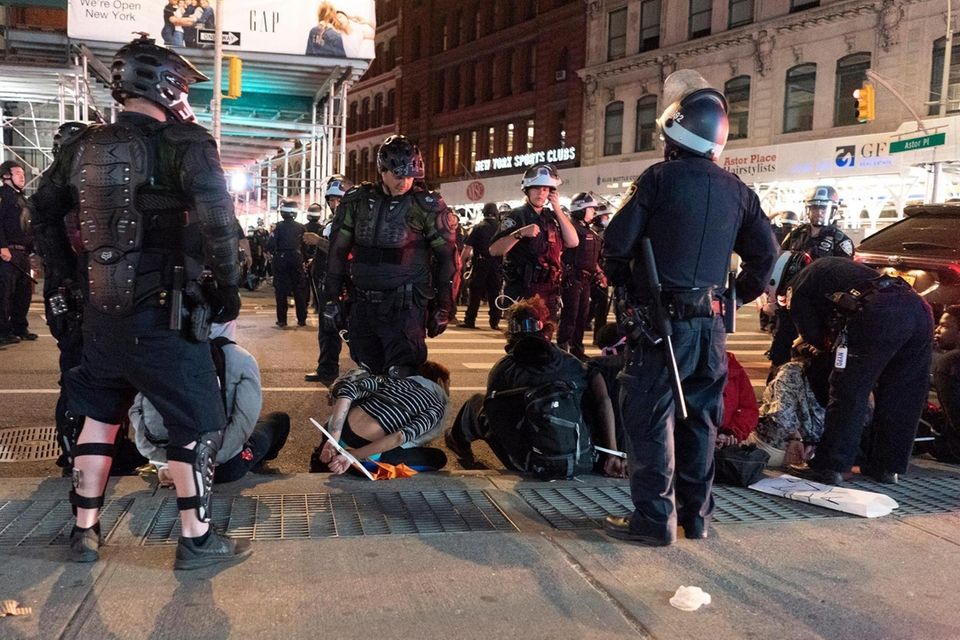 Members of the NYPD detain demonstrators against police