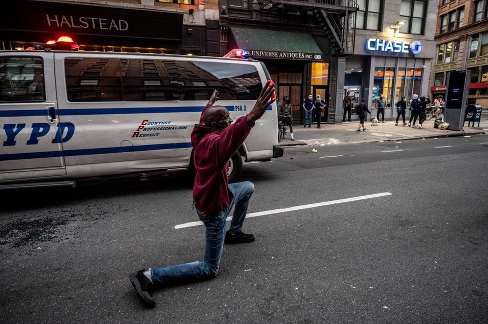 Late night protesters defy an imposed curfew as