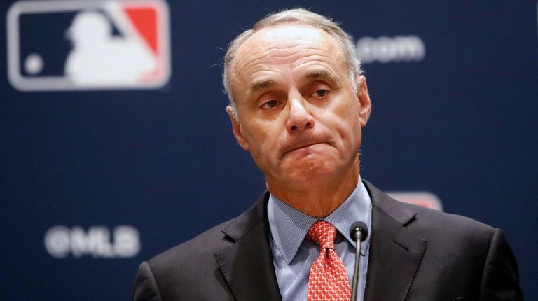 Major League Baseball commissioner Rob Manfred pauses while
