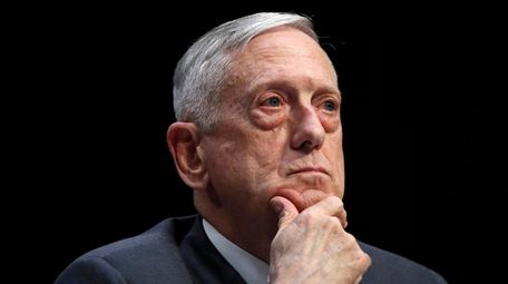 Then-Defense Secretary Jim Mattis listens to a question