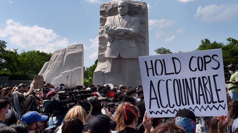 Demonstrators gather Thursday at the Martin Luther King