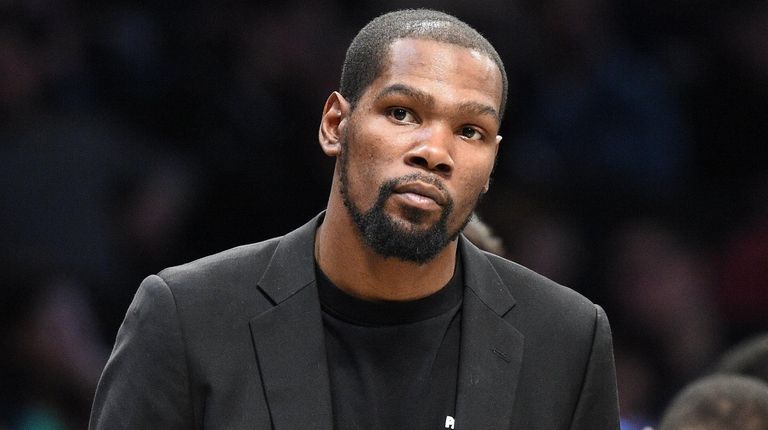 The Nets' Kevin Durant looks on during a