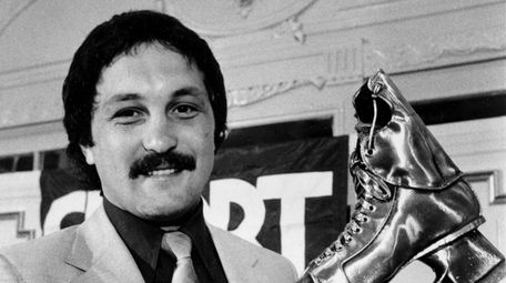 Bryan Trottier, Islanders center, displays his trophy after