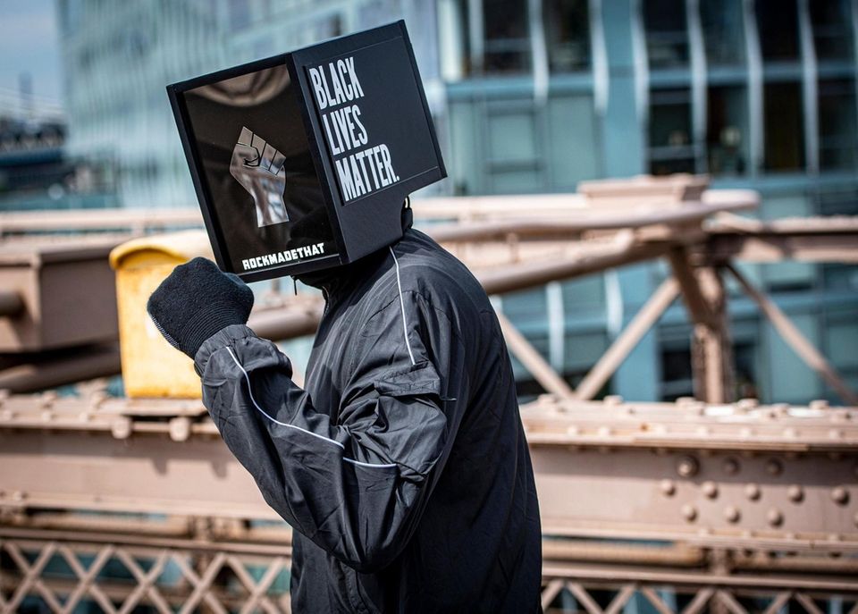 A protester pumping his fist as he crosses