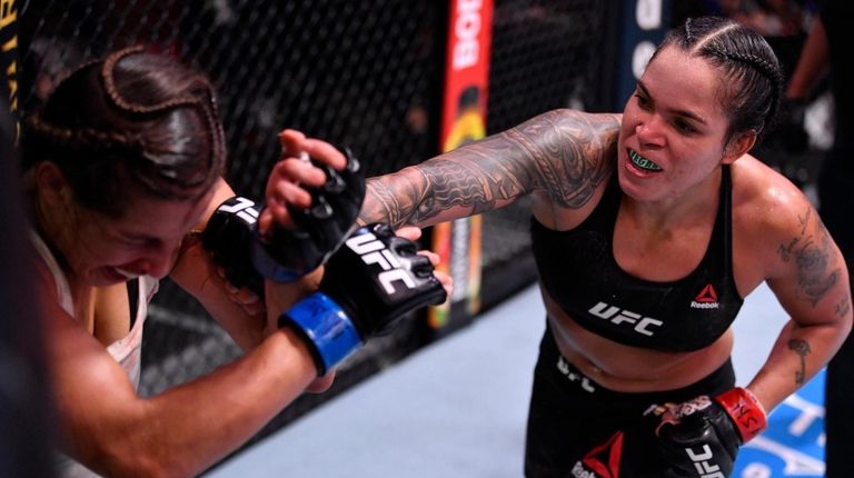 Amanda Nunes, right, punches Felicia Spencer in their