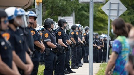 Protesters stage in front of the Suffolk County