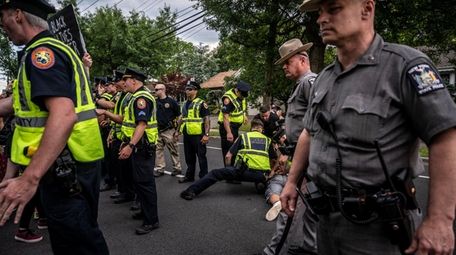 A protester is taken into custody after he