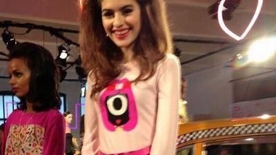 A model wears a one-eyed monster by artist