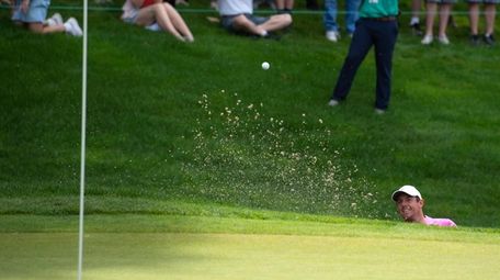 Rory McIlroy hits out of a bunker on