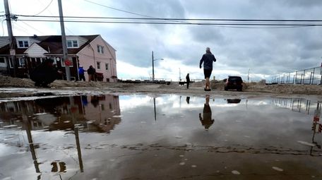 Long Beach residents assess the damage caused by