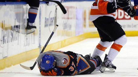 Brian Strait lays on the ice after falling