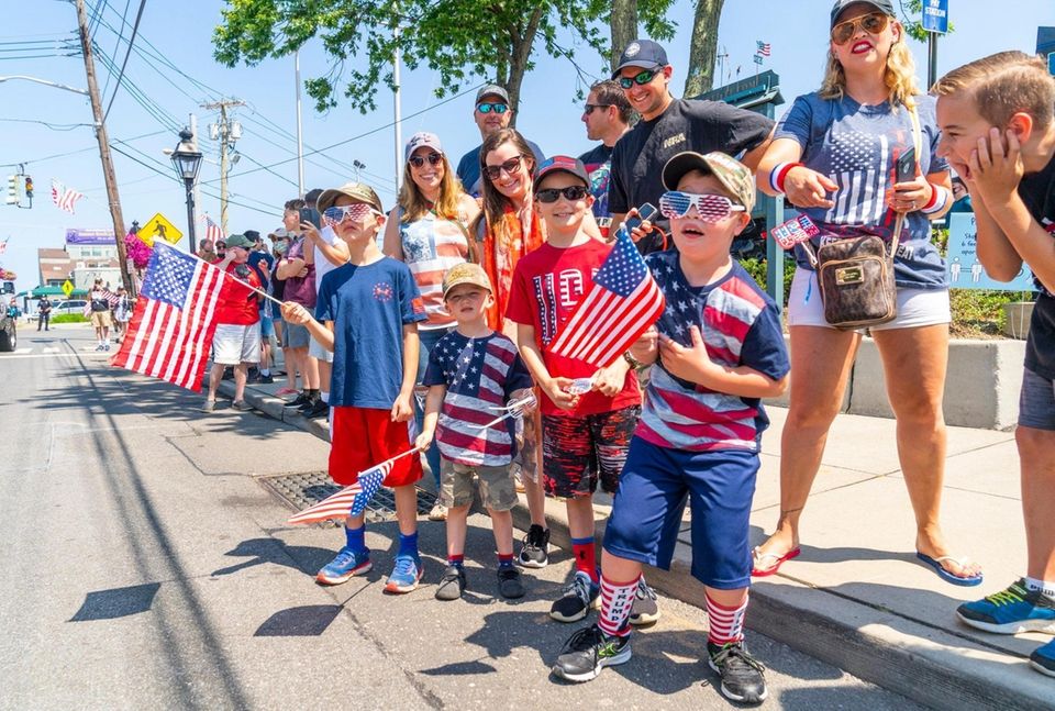 People watch the Patriot Independence Day parade in