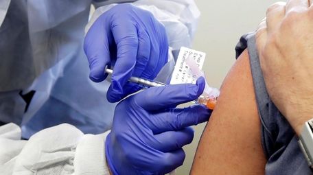 A subject receives a shot in the first-stage