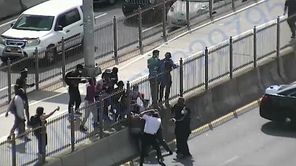 Someone wielding a stick struck three NYPD officers who