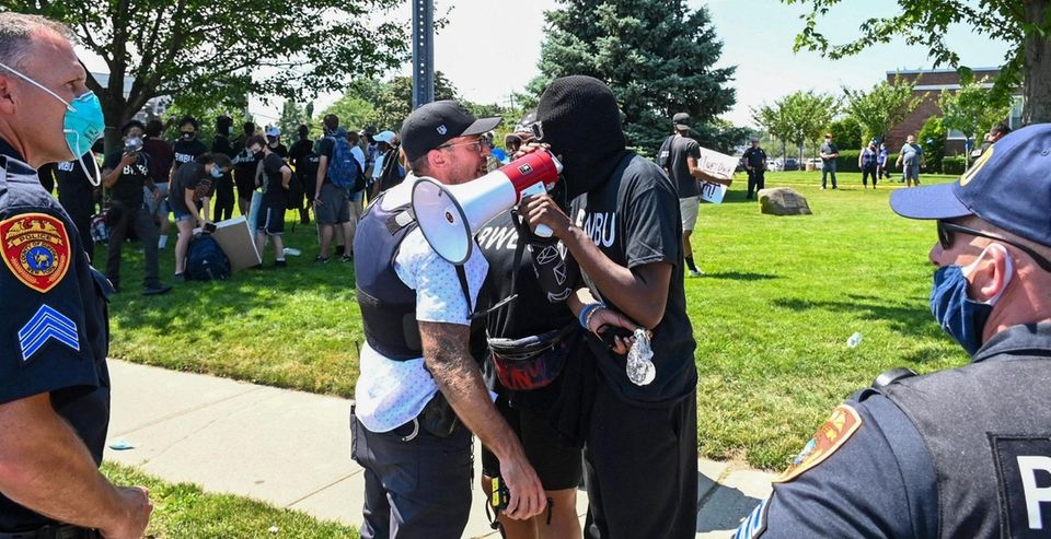 A Black Live Matter protester clashes with a