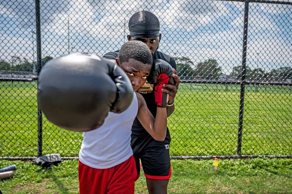 USA boxing coach Jizzixious Bishop helping his student