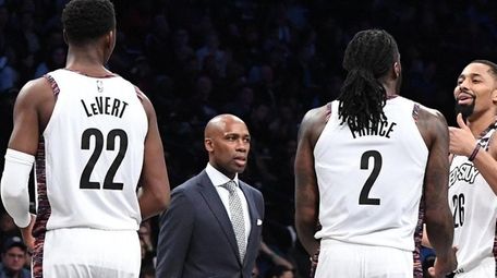 Brooklyn Nets head coach Jacque Vaughn walks onto