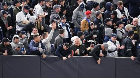 Fans react in rightfield during the fifth inning