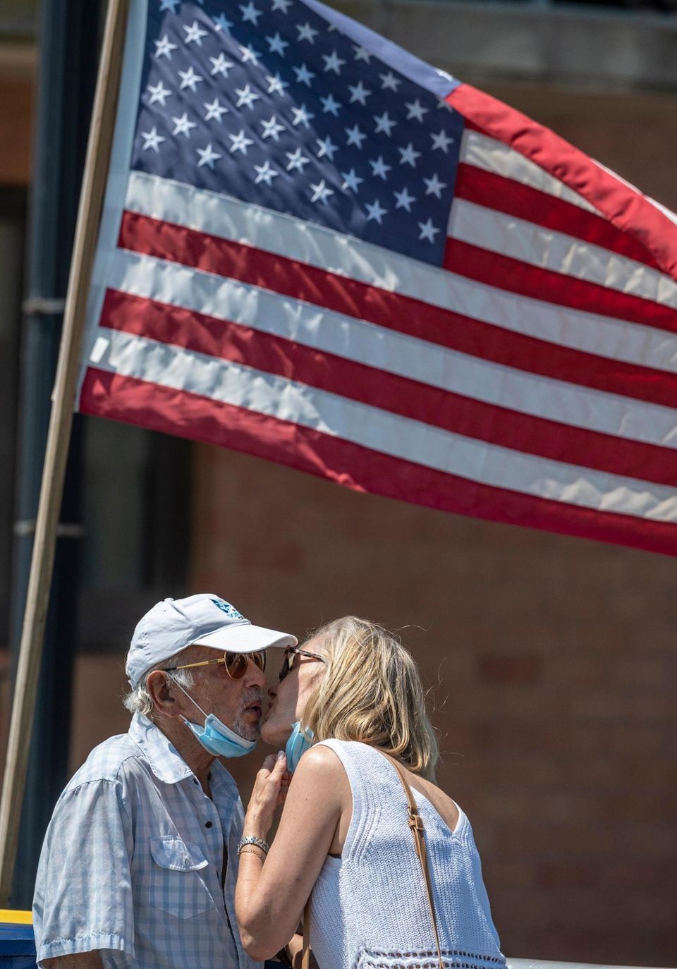 A man wearing a mask getting a kiss