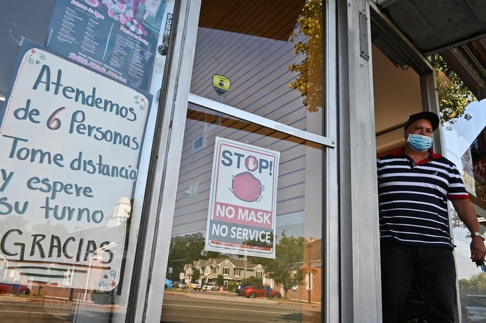 A man wearing a mask walks from Hi-Klass