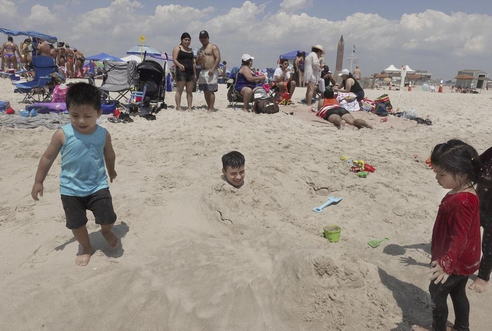 Javier Thom, 18, of Brooklyn, gets buried in