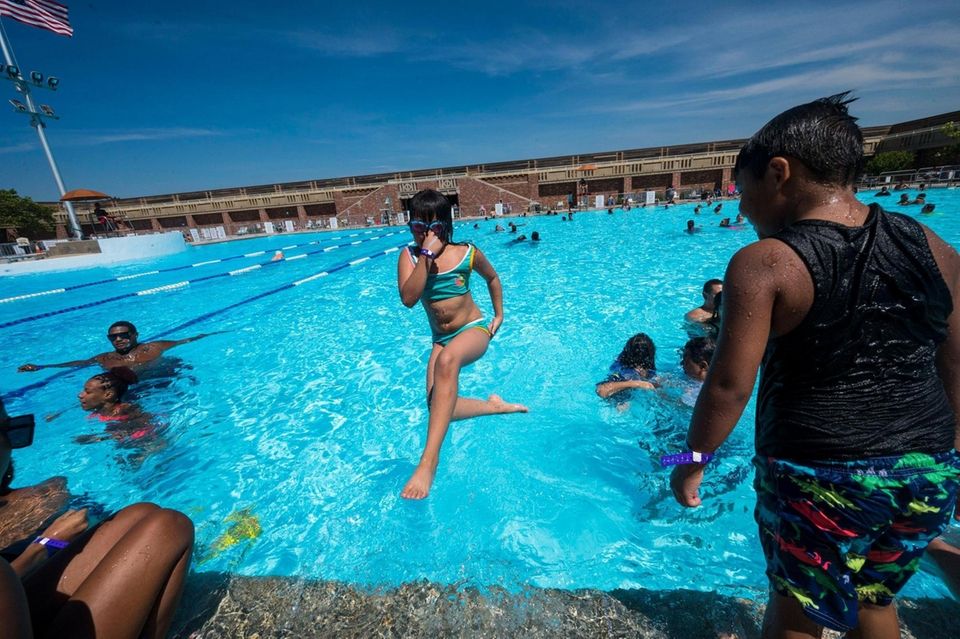 Mercy Alfaro, 8, of Queens stays cool Monday