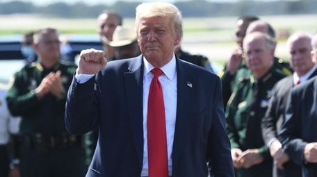 President Donald Trump pumps his fist as he