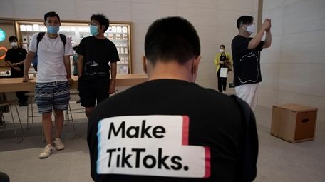 A man wearing a shirt promoting TikTok is