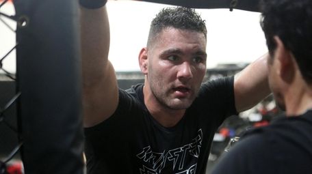 Chris Weidman receives instruction from trainer Ray Longo