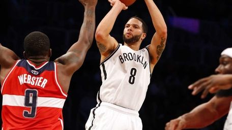 Deron Williams of the Nets shoots a three-point