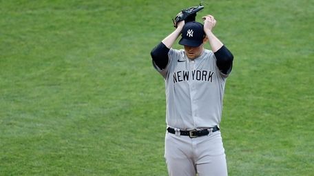 Yankees starting pitcher Jordan Montgomery adjusts his cap