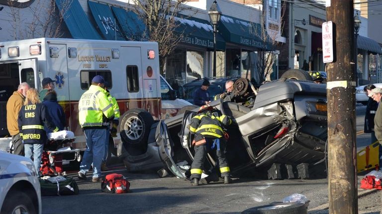 Rescuers work to free the driver of a