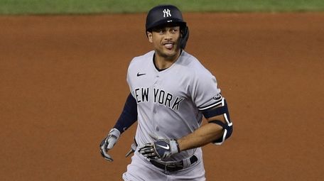 Giancarlo Stanton #27 of the Yankees celebrates a
