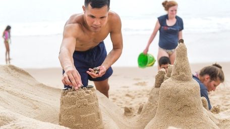 Beachgoers building sand castles at Hither Hills State