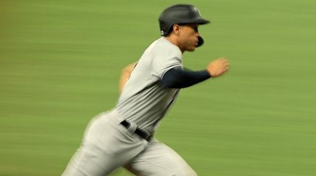 Giancarlo Stanton of the Yankees scores a run