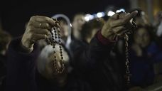 Women hold rosaries at St Peter basilica during