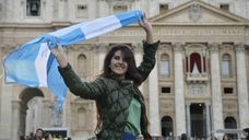 A women poses with an Argentinian flag on