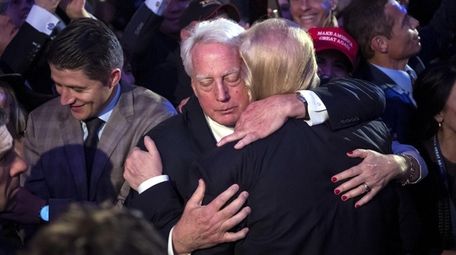 Robert Trump hugs his brother, Donald Trump, in