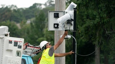 A worker installs one of the 81 cameras