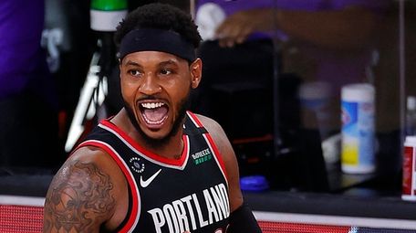 The Trail Blazers' Carmelo Anthony reacts during the
