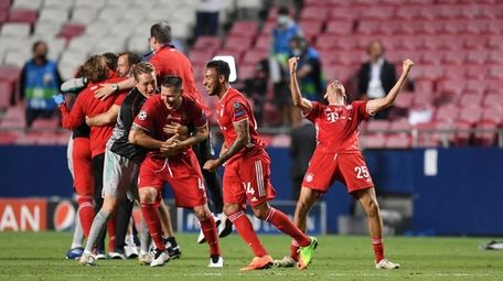 Bayern's Thomas Mueller, right, celebrates after winning the